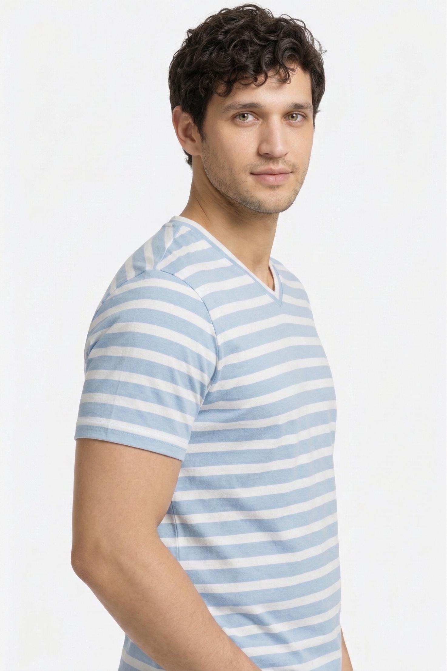 Man wearing a pure cotton blue and white striped shirt against a plain background