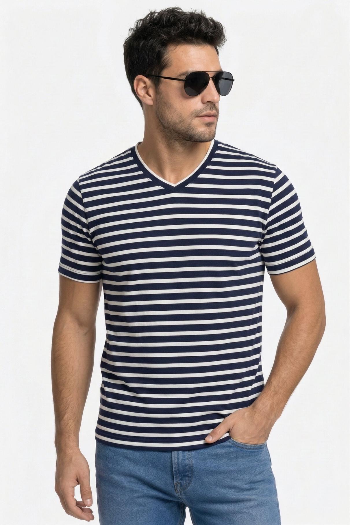 Man wearing a navy and white striped t-shirt with sunglasses on a light gray background