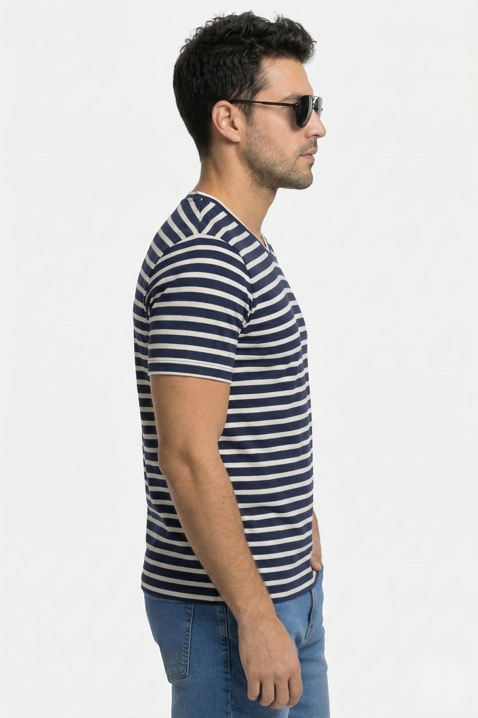 Man wearing a striped shirt and sunglasses on a plain background