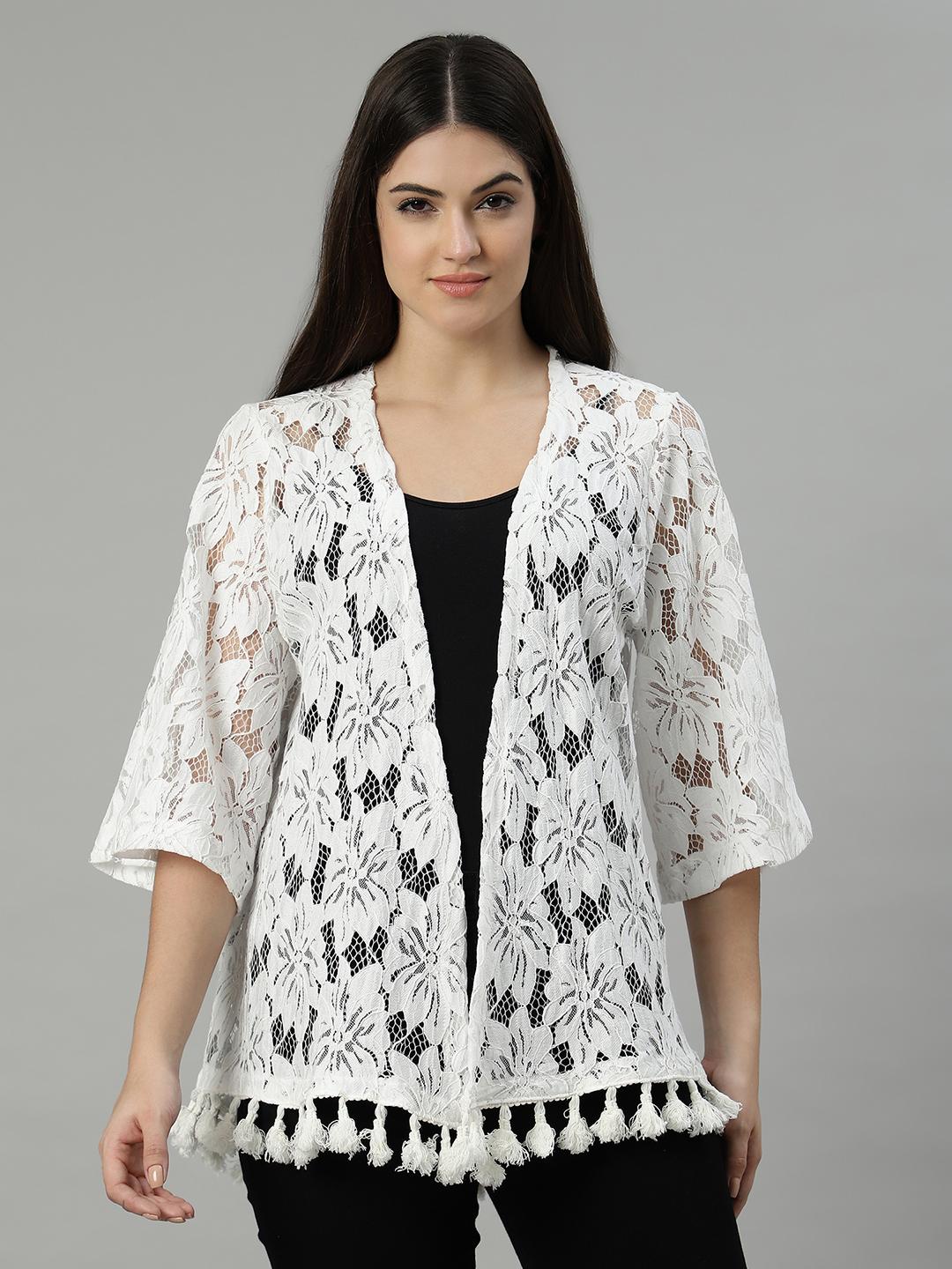 Woman wearing a white lace kimono-style shrug on a gray background