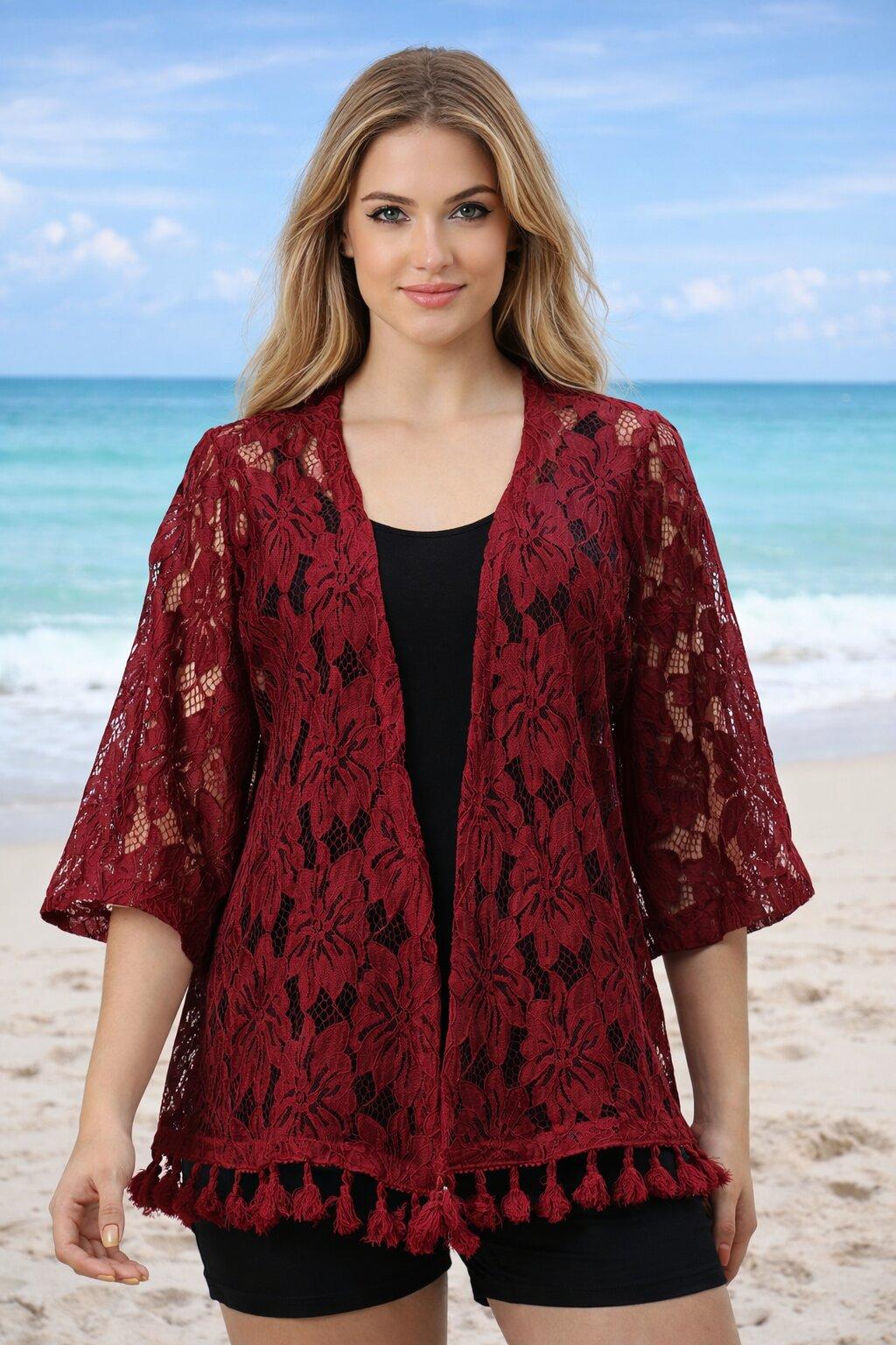 Woman wearing a red lace kimono on a beach